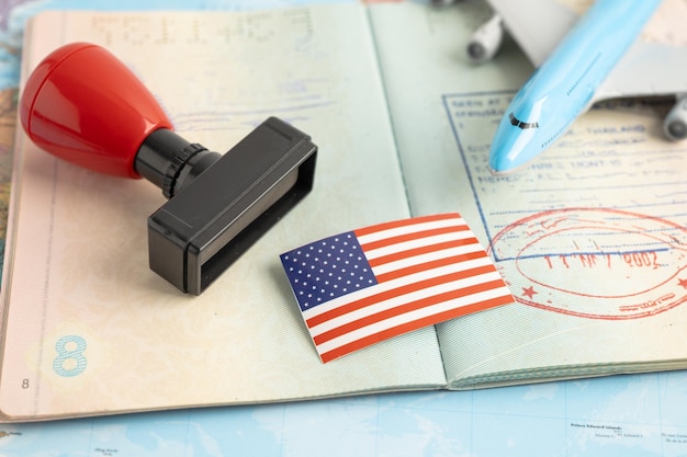 A close-up of a U.S. passport with visa stamps, symbolizing the legal processes and documentation required for immigration. The image should emphasize the importance of compliance.