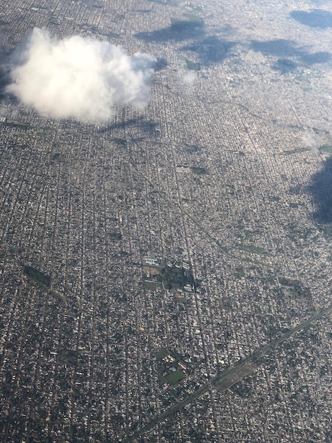 A satellite image showing the reduction in smog and pollution over a major U.S. city, highlighting the positive impact of new emissions standards and clean energy policies. The image is split, with one side showing the city before the policies and the other side showing the improved air quality after.
