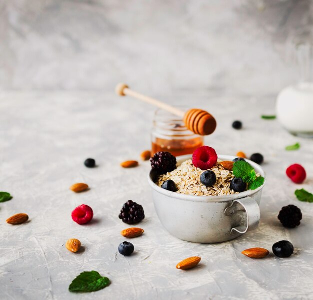 A close-up shot of a nutritious breakfast consisting of oatmeal with fresh berries, nuts, and a drizzle of honey, placed on a wooden table with sunlight streaming in, emphasizing health and vitality.