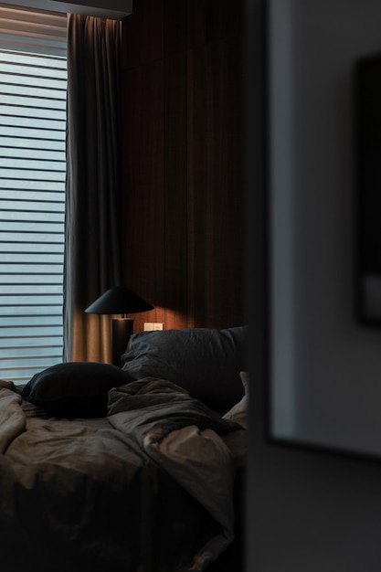 An image depicting a dark and quiet bedroom with blackout curtains and a comfortable bed, emphasizing a sleep-conducive environment. Highlight the factors that create a perfect sanctuary for sleep.