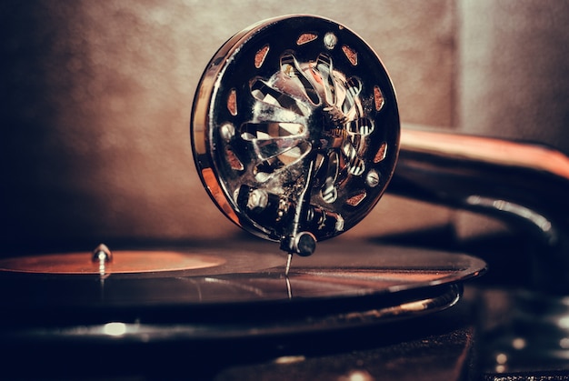 Close-up of a vintage gramophone playing a record, capturing the nostalgic essence of early American music recording technology and its impact on the music industry.